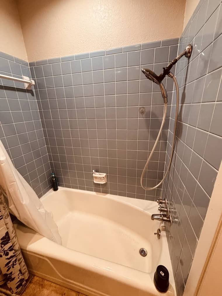 Outdated blue tile tub and shower before remodeling