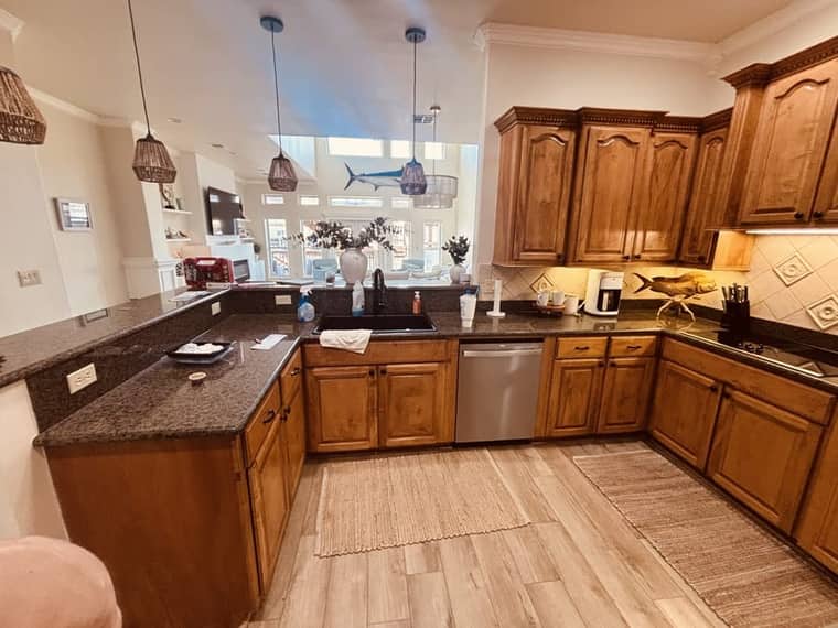 Kitchen with dark granite countertops before remodeling