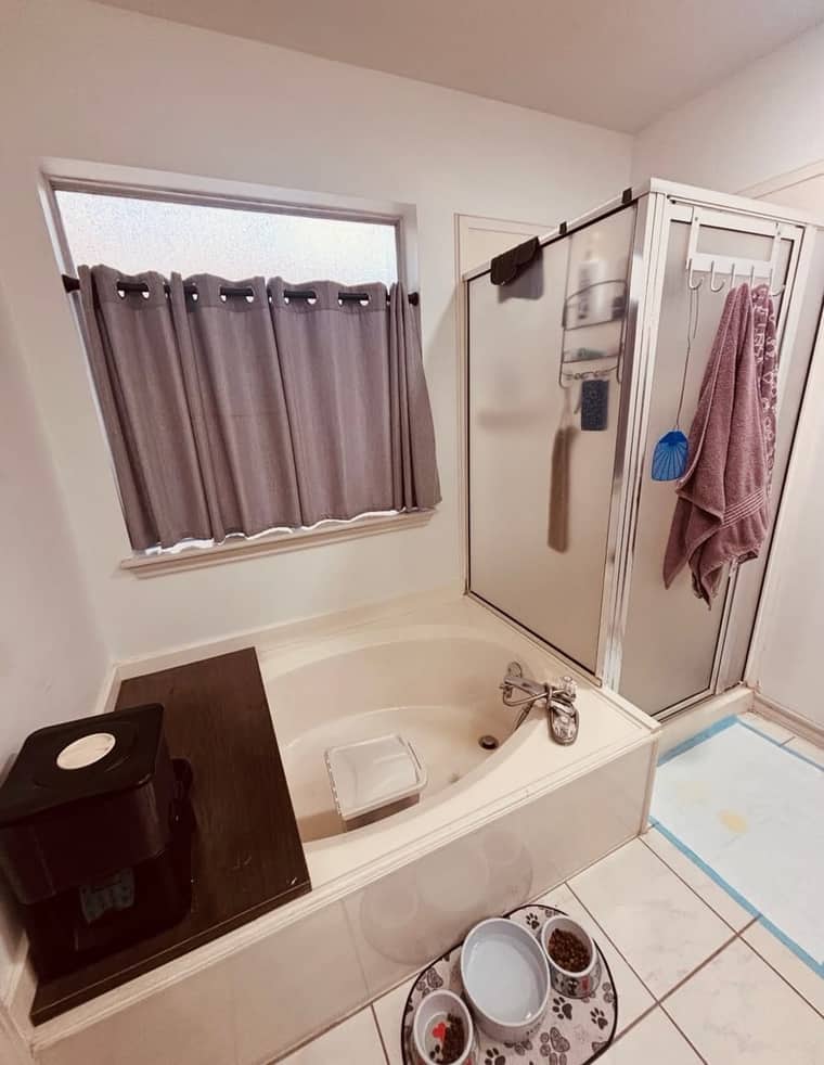 Old garden tub and framed glass shower before remodeling