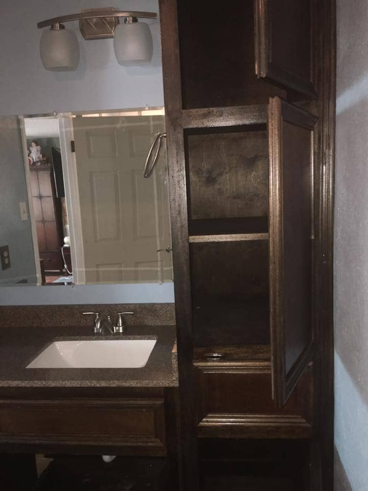 Custom dark wood vanity with storage cabinet in Corpus Christi bathroom