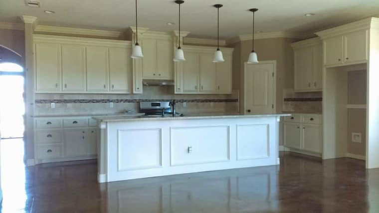 Spacious white kitchen remodel with island and pendant lights in Corpus Christi