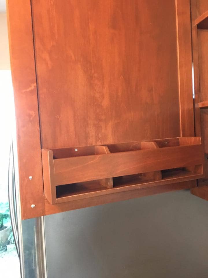 Custom spice rack cabinet above refrigerator in Corpus Christi