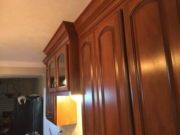 Custom crown molding wood cabinets with glass fronts in Corpus Christi