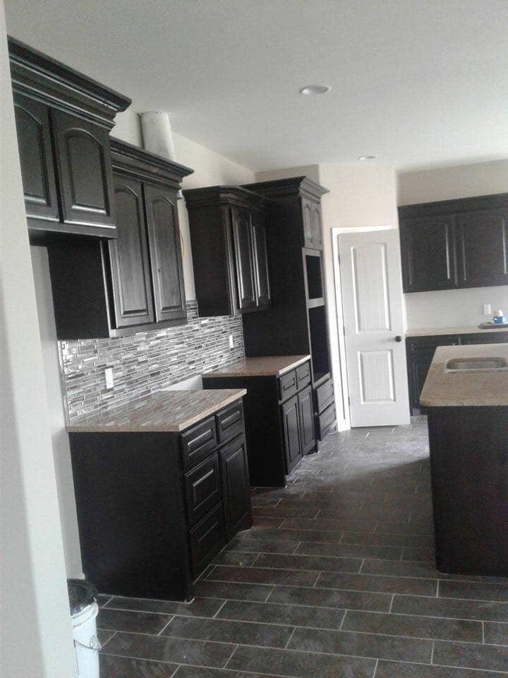 Dark espresso cabinet kitchen with glass tile backsplash in Corpus Christi