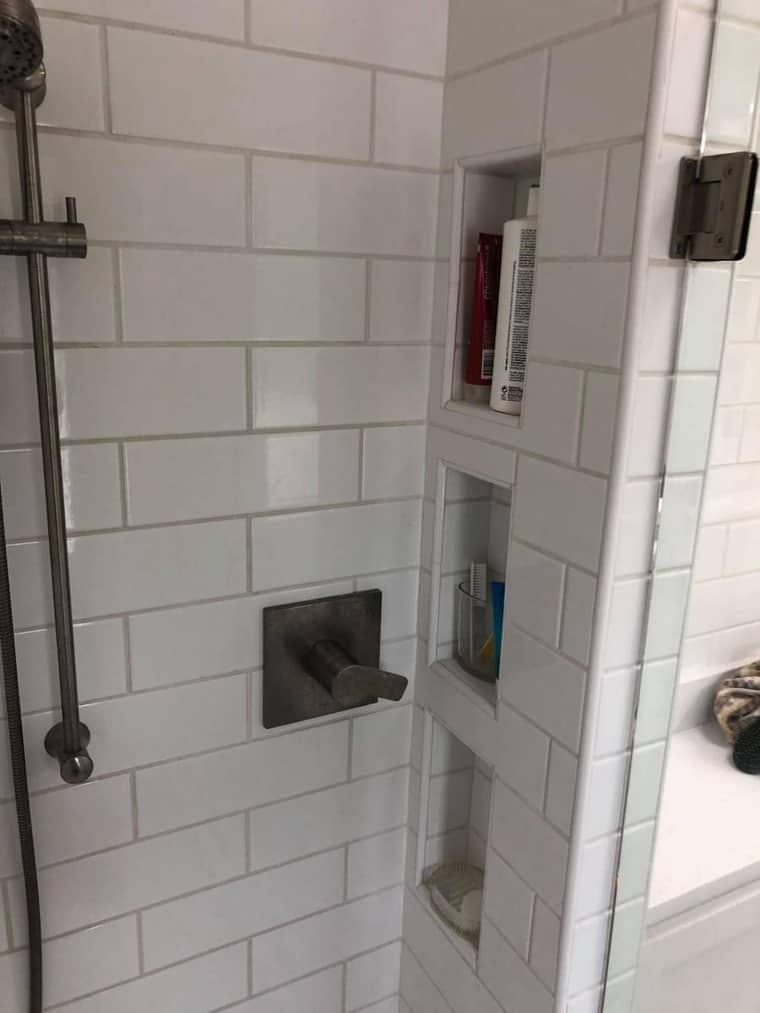 Subway tile shower with built-in niche and glass enclosure in Corpus Christi
