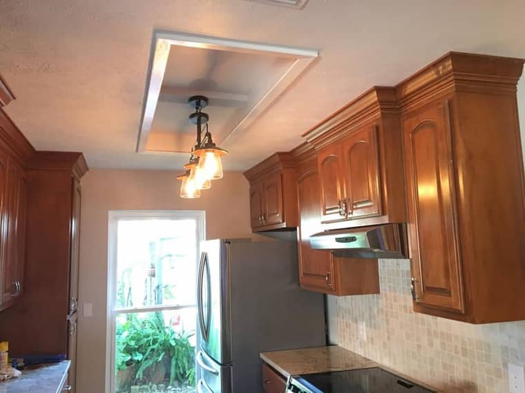 Kitchen renovation with crown molding cabinets and pendant lighting in Corpus Christi