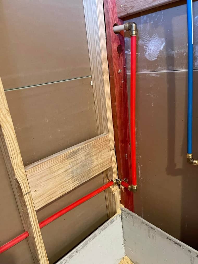 PEX hot and cold water line installation behind shower wall in Corpus Christi