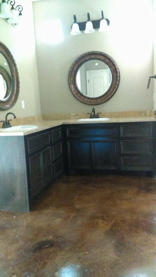 Custom dark vanity bathroom remodel with stained concrete floors in Corpus Christi