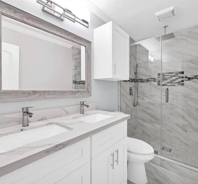 Modern white bathroom remodel with marble shower and double vanity in Corpus Christi