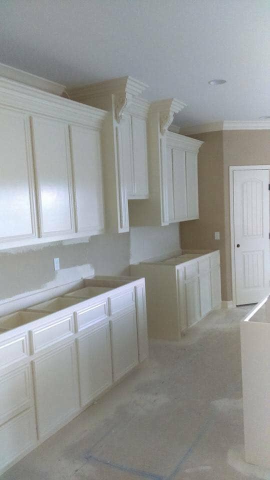White cabinet installation with crown molding in Corpus Christi kitchen