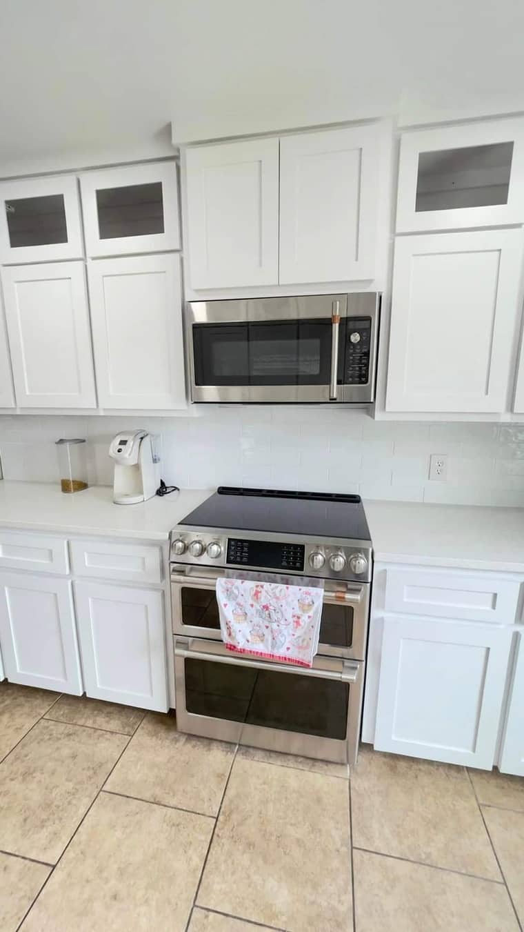 White shaker kitchen with stainless steel appliances and glass-front cabinets in Corpus Christi